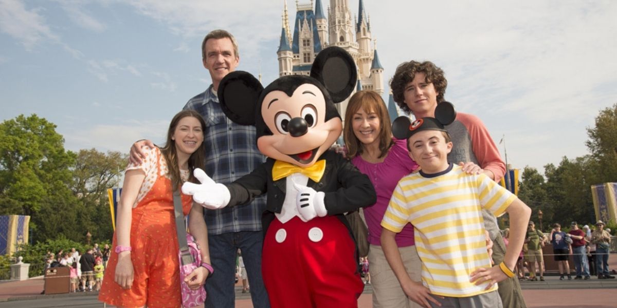 The middle cast poses with Mickey in front of Cinderella's Castle.