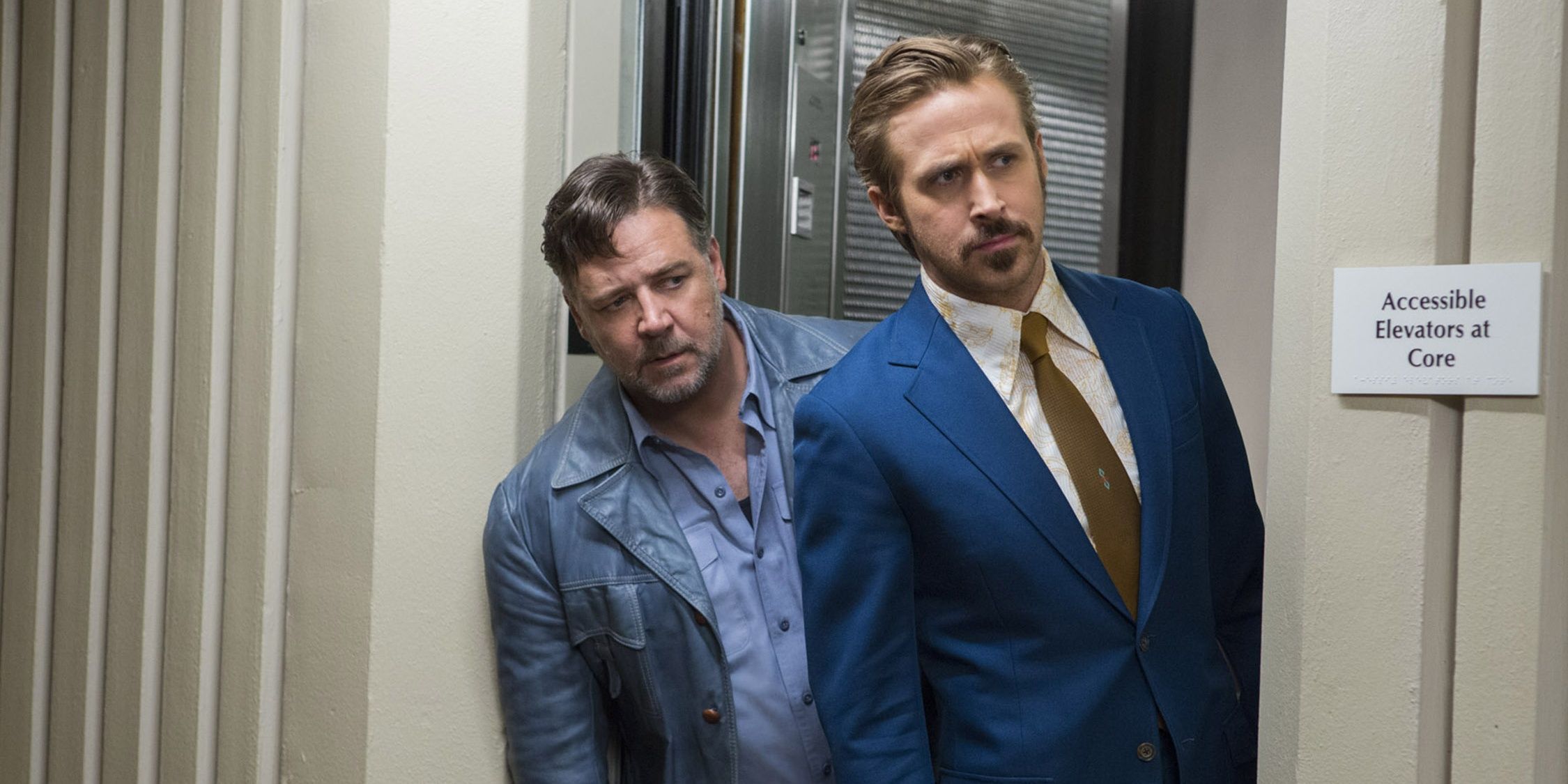 Ryan Gosling and Russell Crowe coming out of the elevator The Nice Guys