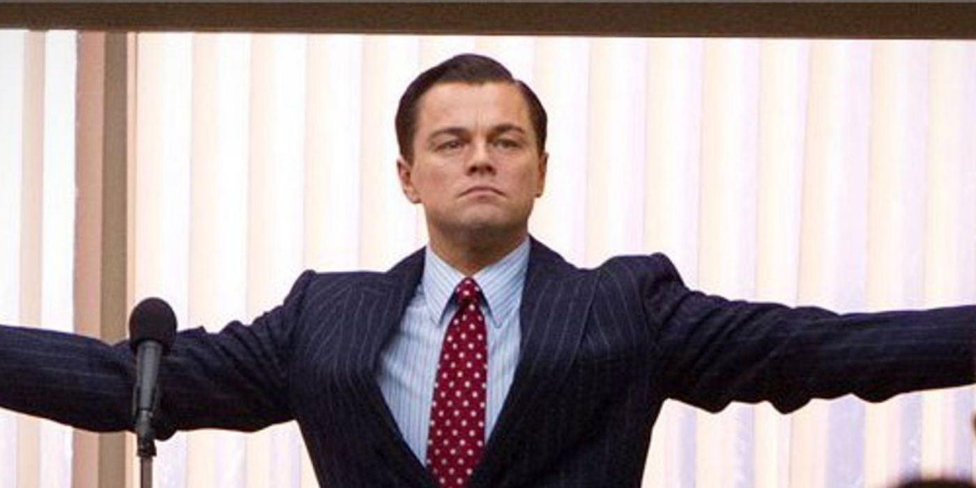 Leonardo DiCaprio with his arms raised in triumph in The Wolf of Wall Street