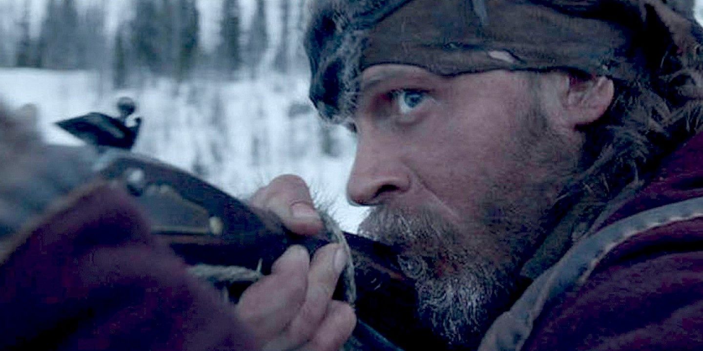 John Fitzgerald aims his gun in the forest in The Revenant