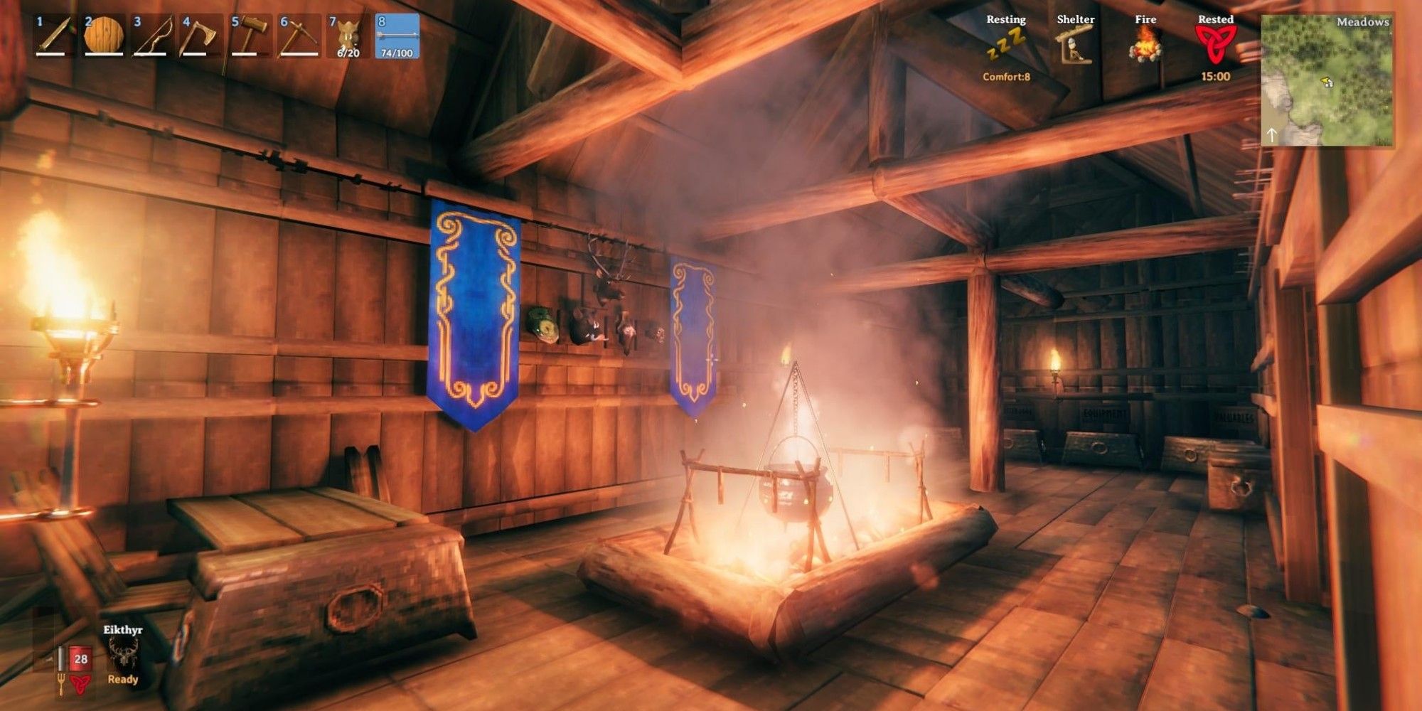 A player places an open, ventilated fire in the middle of their longhouse in Valheim