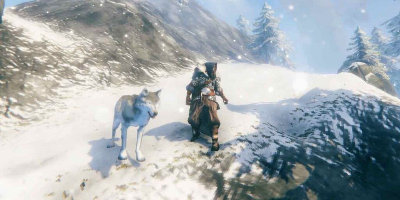 Un jugador se enfrenta a un lobo en la cima de una montaña nevada en Valheim.