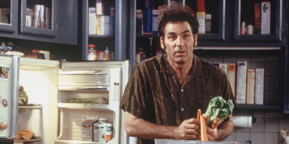 Kramer taking carrots out of Jerry's fridge.