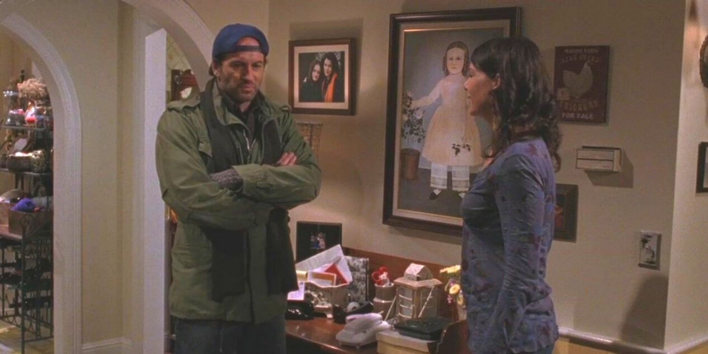 Luke with his arms crossed while talking to Lorelai in Gilmore Girls