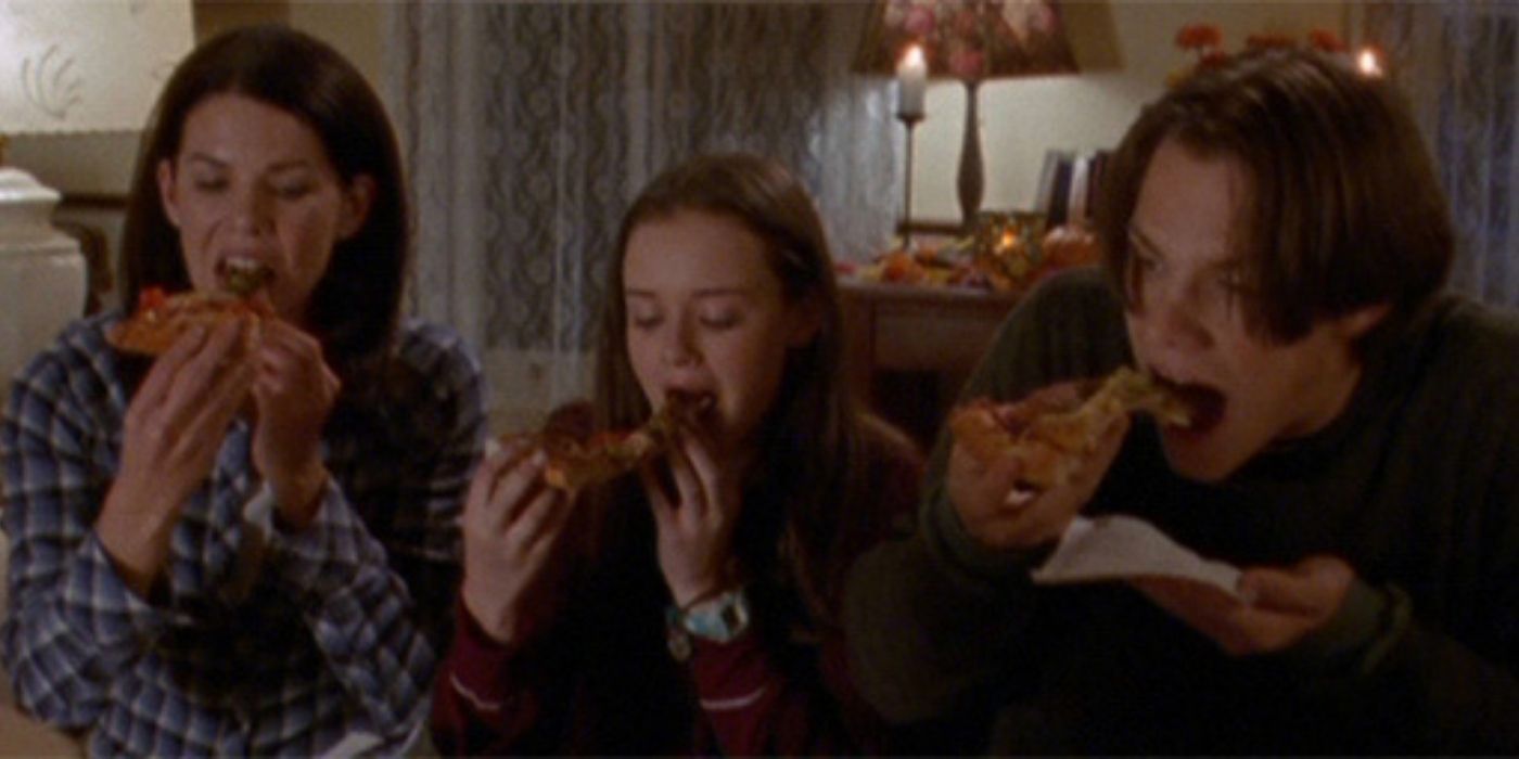Lorelai, Rory, and Dean eating pizza at home on Gilmore Girls