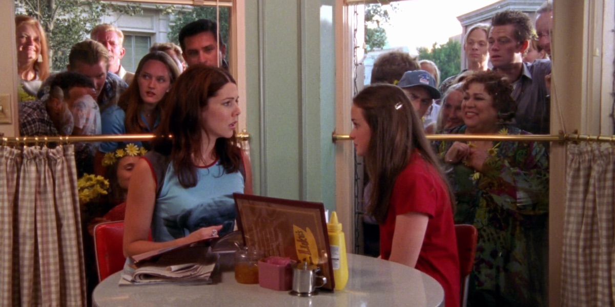 Lorelai and Rory talk in front of a crowd