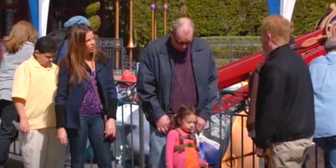 Gloria and Jay watch Lily while she's on a leash at Disneyland in Modern Family