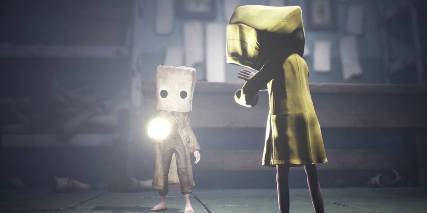 A character shining a flashlight on someone in Little Nightmares 2.