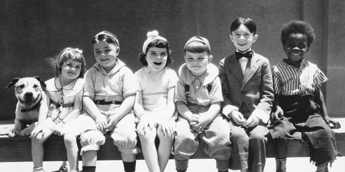 The original Little Rascals sit on a bench