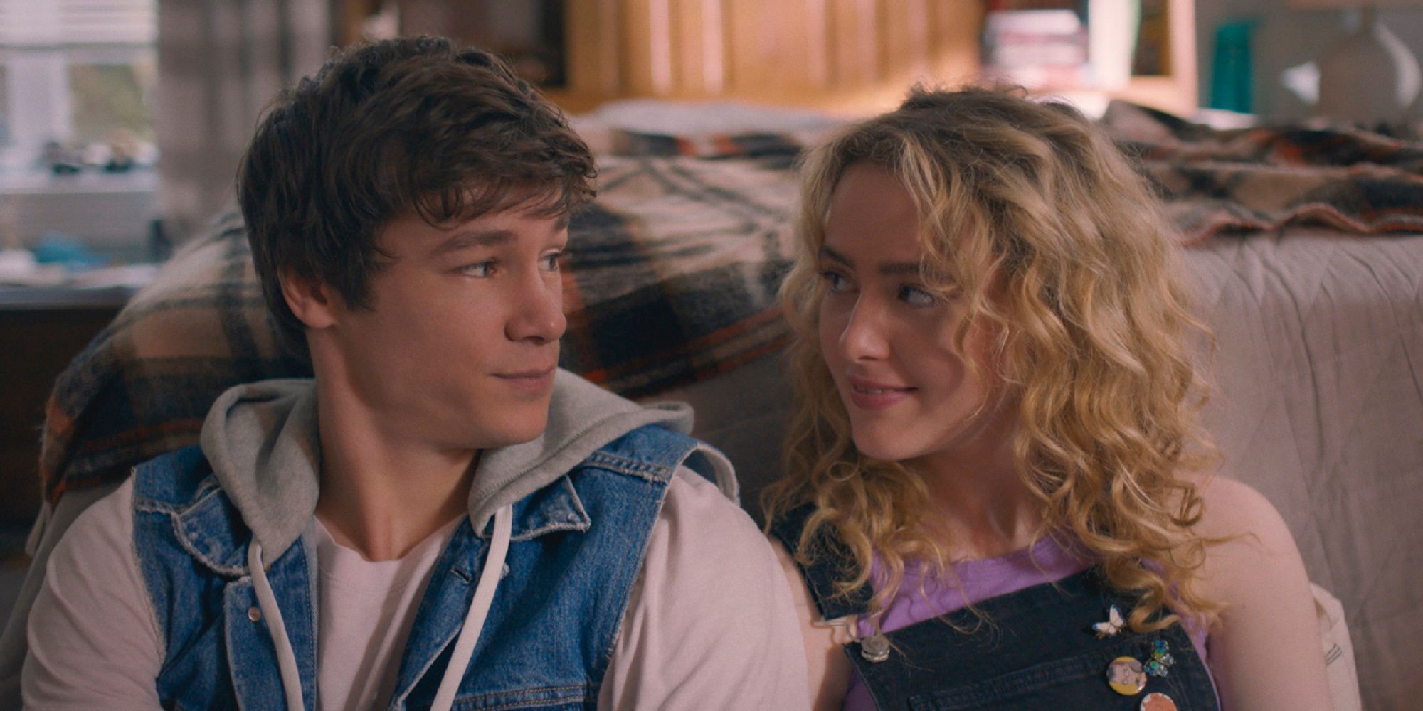 Kathryn Newton and Kyle Allen look at each other in a bedroom in The Map of Tiny Perfect Things