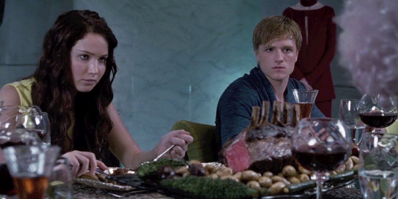 Peeta and Katniss having dinner at the Tribute Centre in The Hunger Games