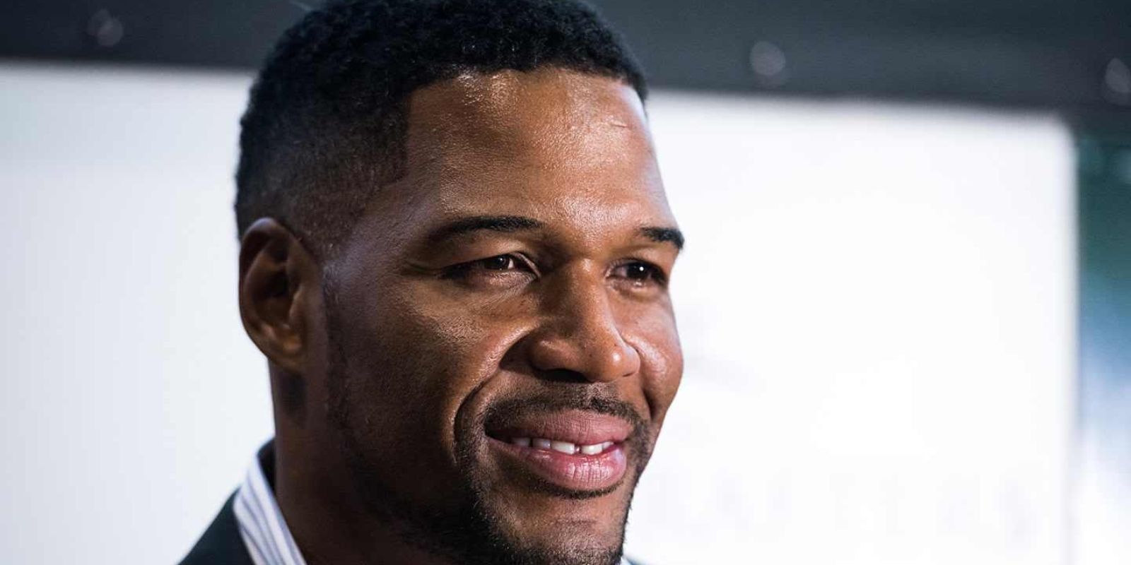 Michael Strahan smiling for a photograph