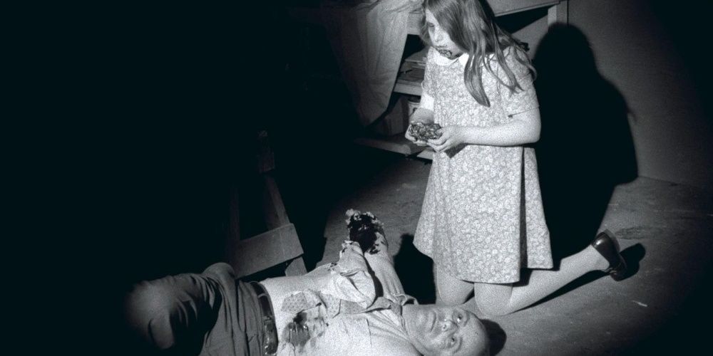 Zombie child eating her father in Night of the Living Dead