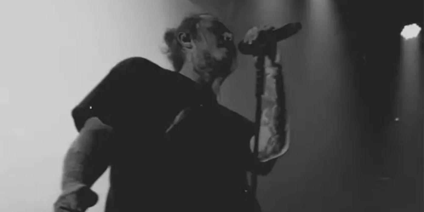 Post Malone singing to a crowd in the music video for Better Now