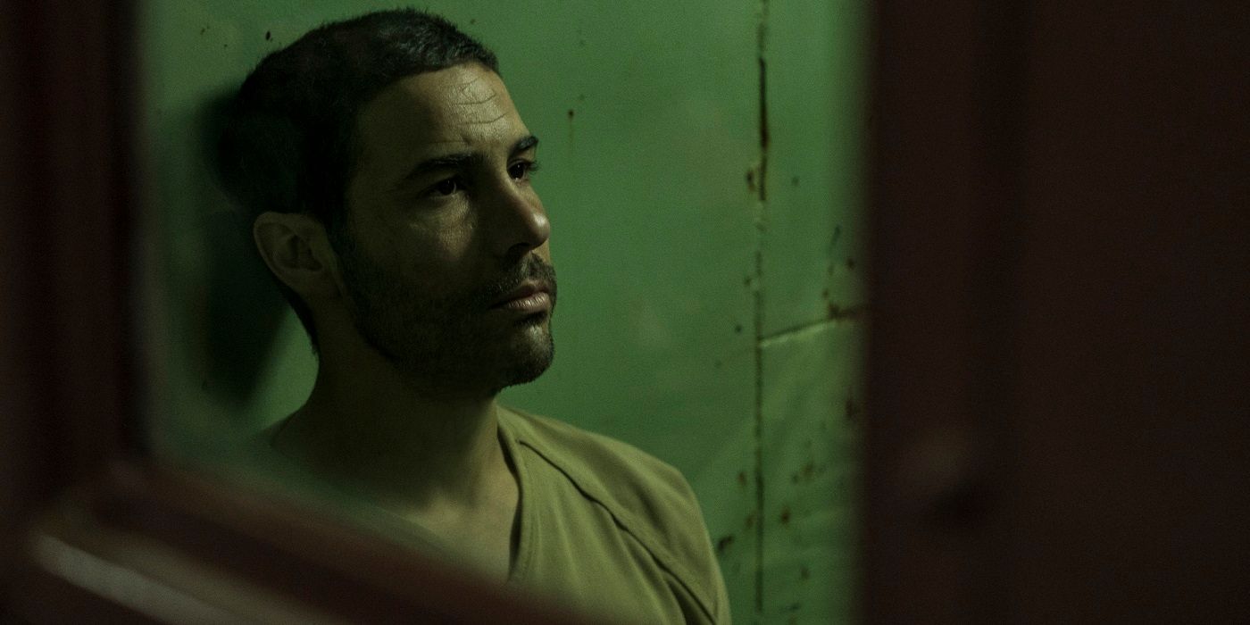 Tahar Rahim sitting in a jail cell in The Mauritanian