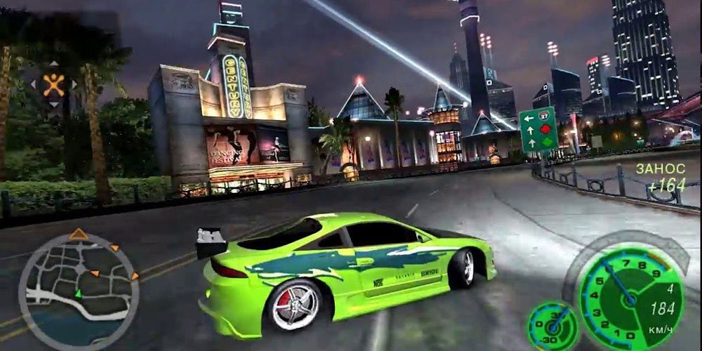 A green car drifts around a bend in Need for Speed Underground 2