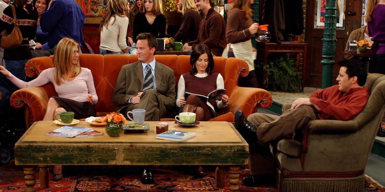 Scene from Friends with the group sitting on the orange couch at Central Perk