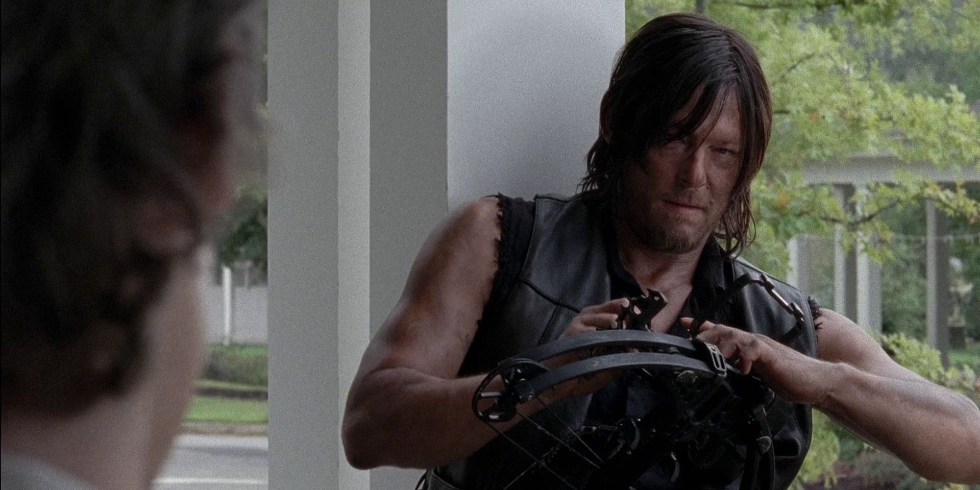 Daryl sitting on the porch with Carol in Season 5 Episode 12 of The Walking Dead