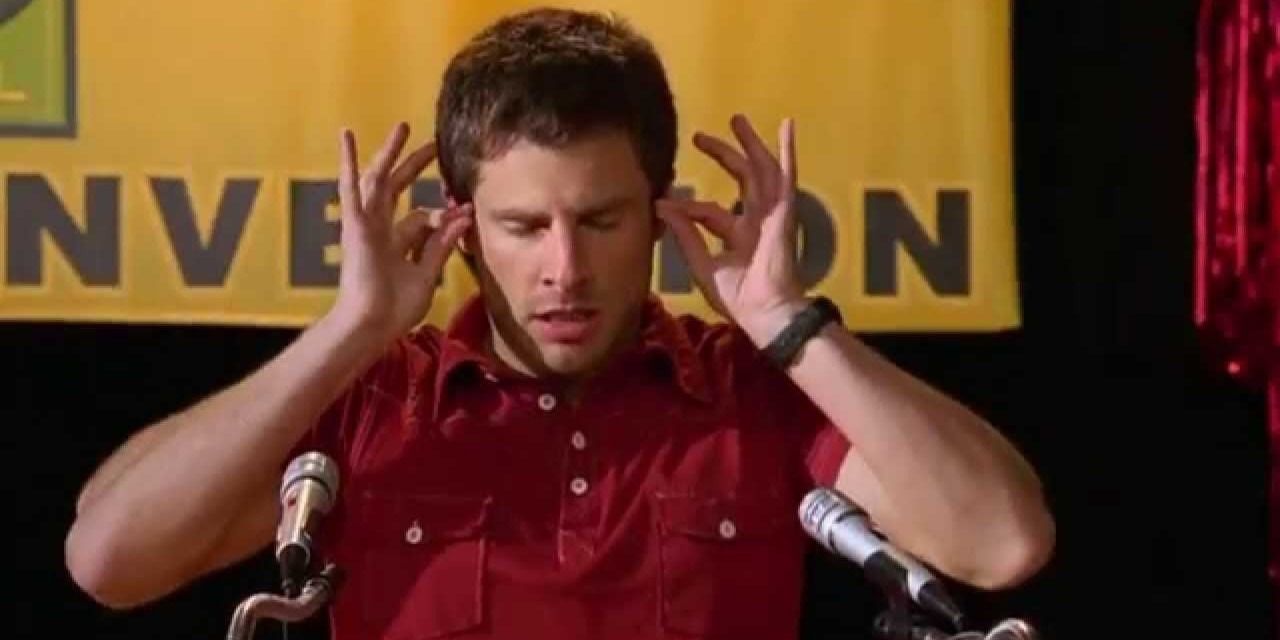 Shawn Spencer touches his temples during a psychic episode in Psych