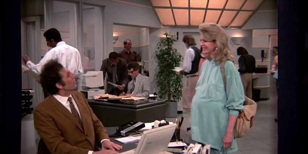 Kramer setting at a desk on the set of Murphy Brown