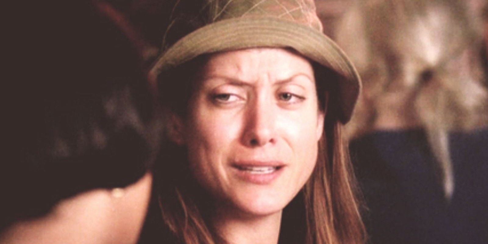 An image of Addison in Grey's Anatomy. She is seen to be wearing a rain hat and crying. She also appears to be talking to Bailey 