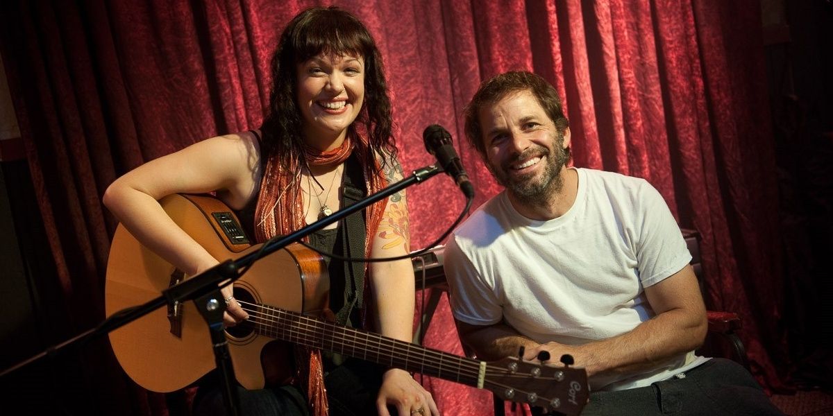Allison Crowe with Zack Snyder, both smiling at the camera