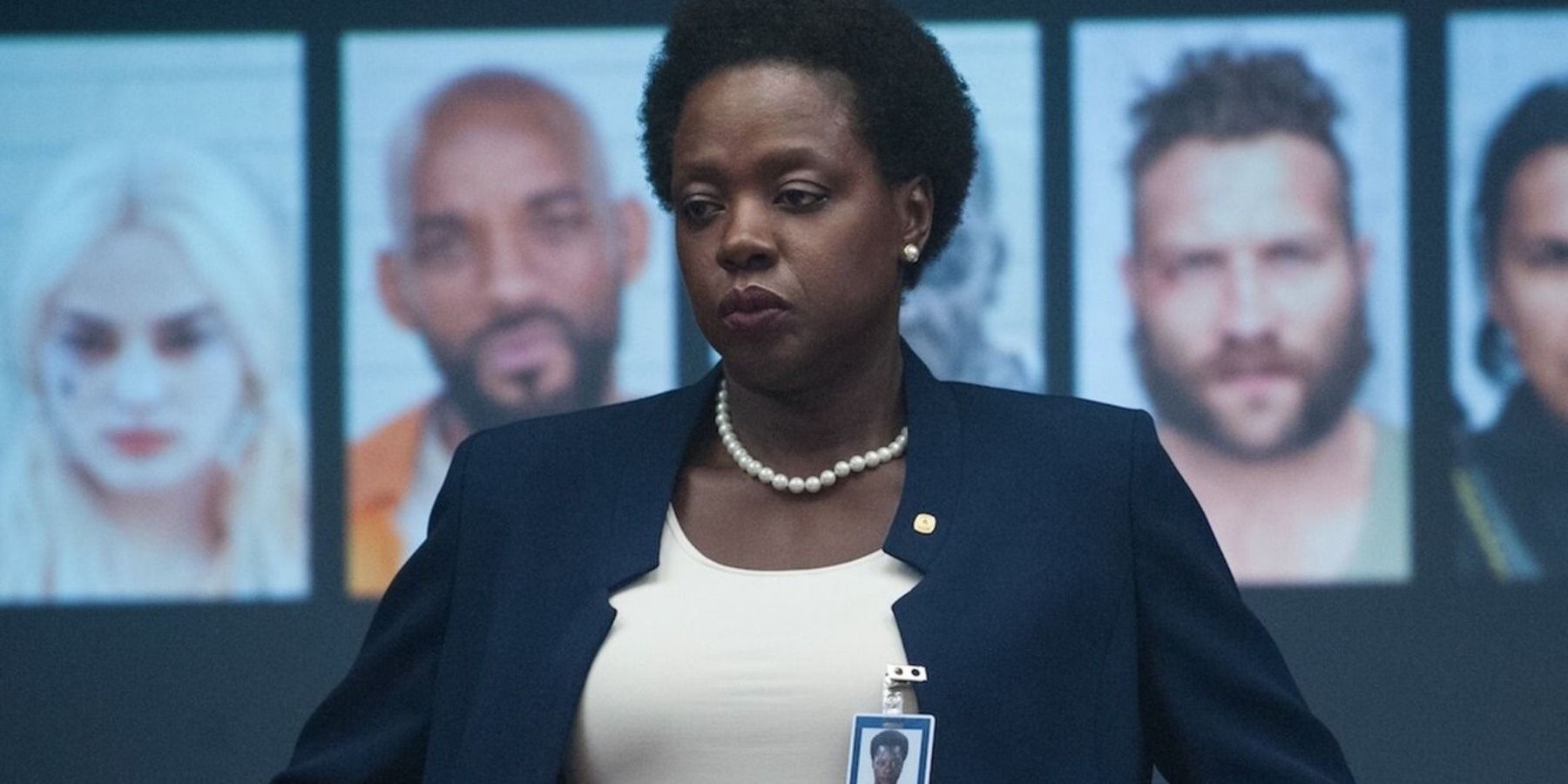 Amanda Waller with photos of Suicide Squad members behind her