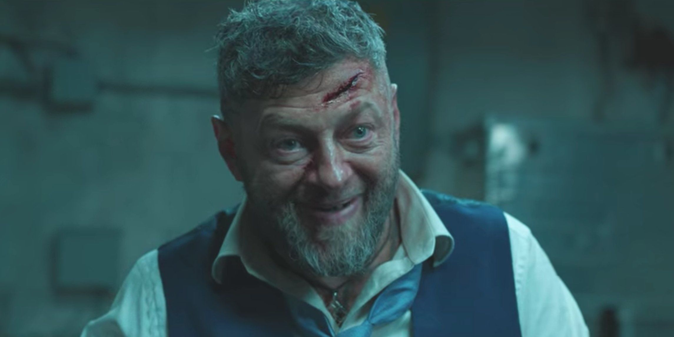 Andy Serkis as villain Ulysses Klaue in Black Panther with villanous smile