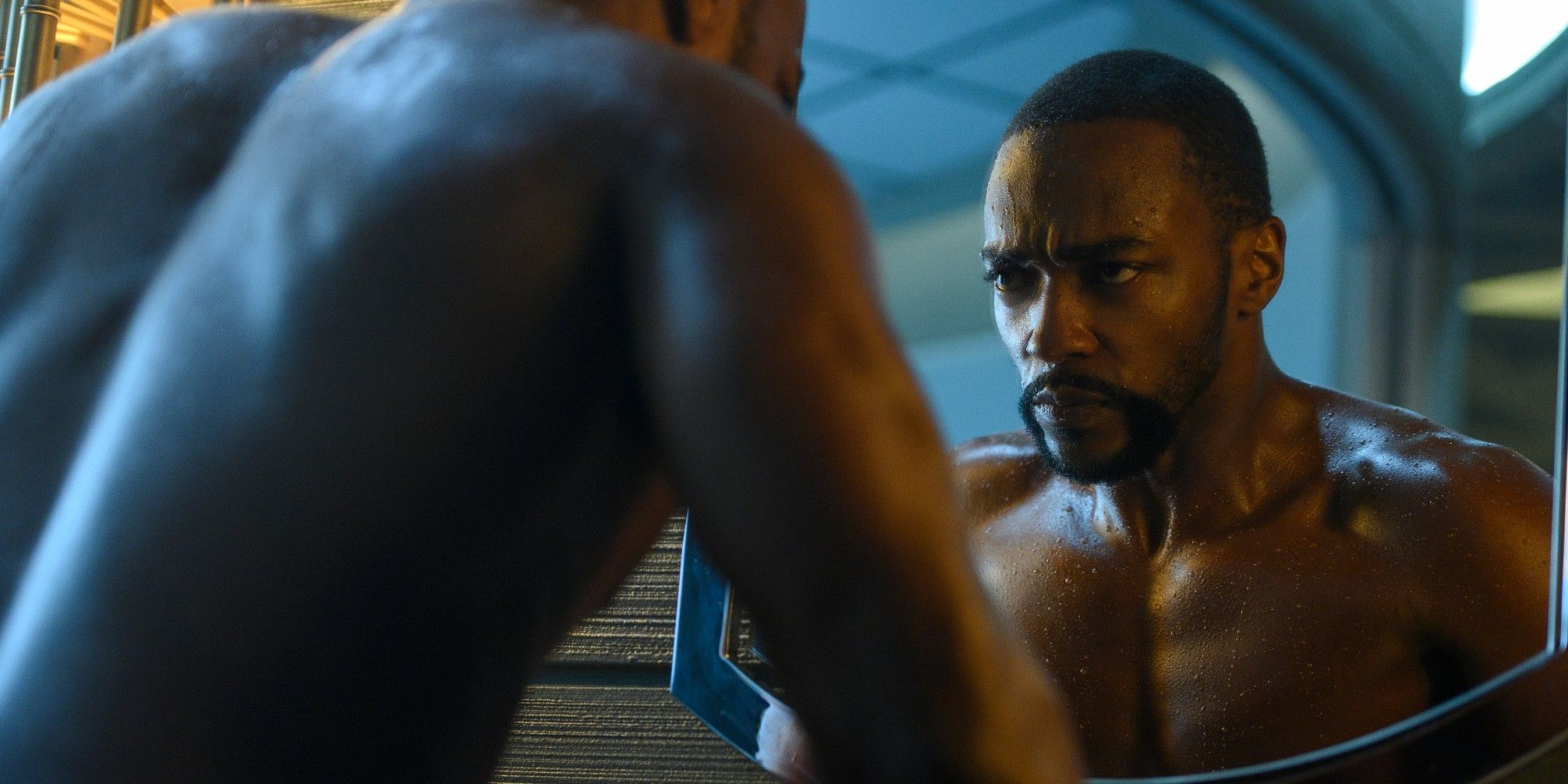 Anthony Mackie as the new host body of Takeshi Kovacs as he looks at himself in the mirror in Altered Carbon