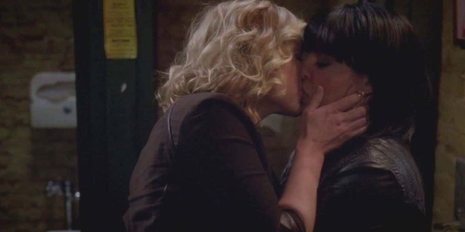 Meredith and Callie kissing in the bathroom at The Emerald City bar. Both women are wearing a dark ensemble, with Arizona wearing a brown shirt and Callie a leather jacket