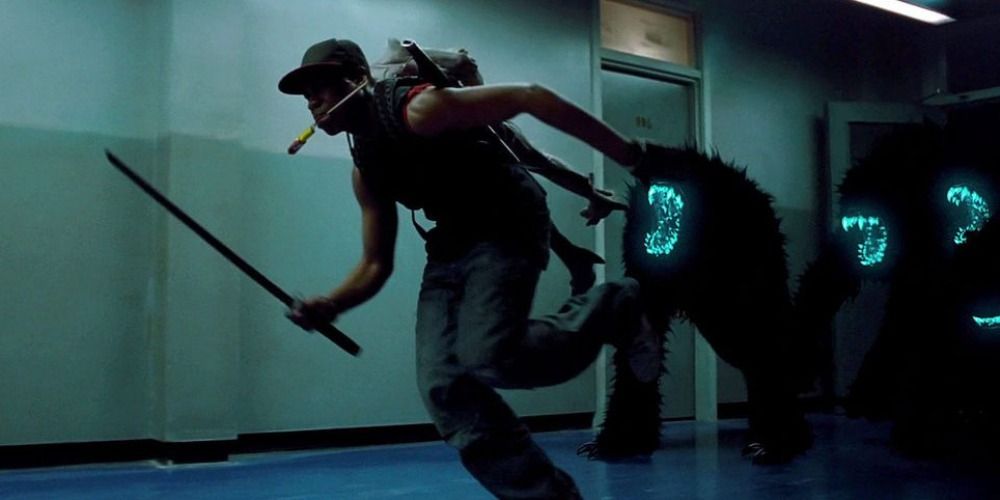 Moses running with a backpack and weapon from light up creatures in Attack the Block
