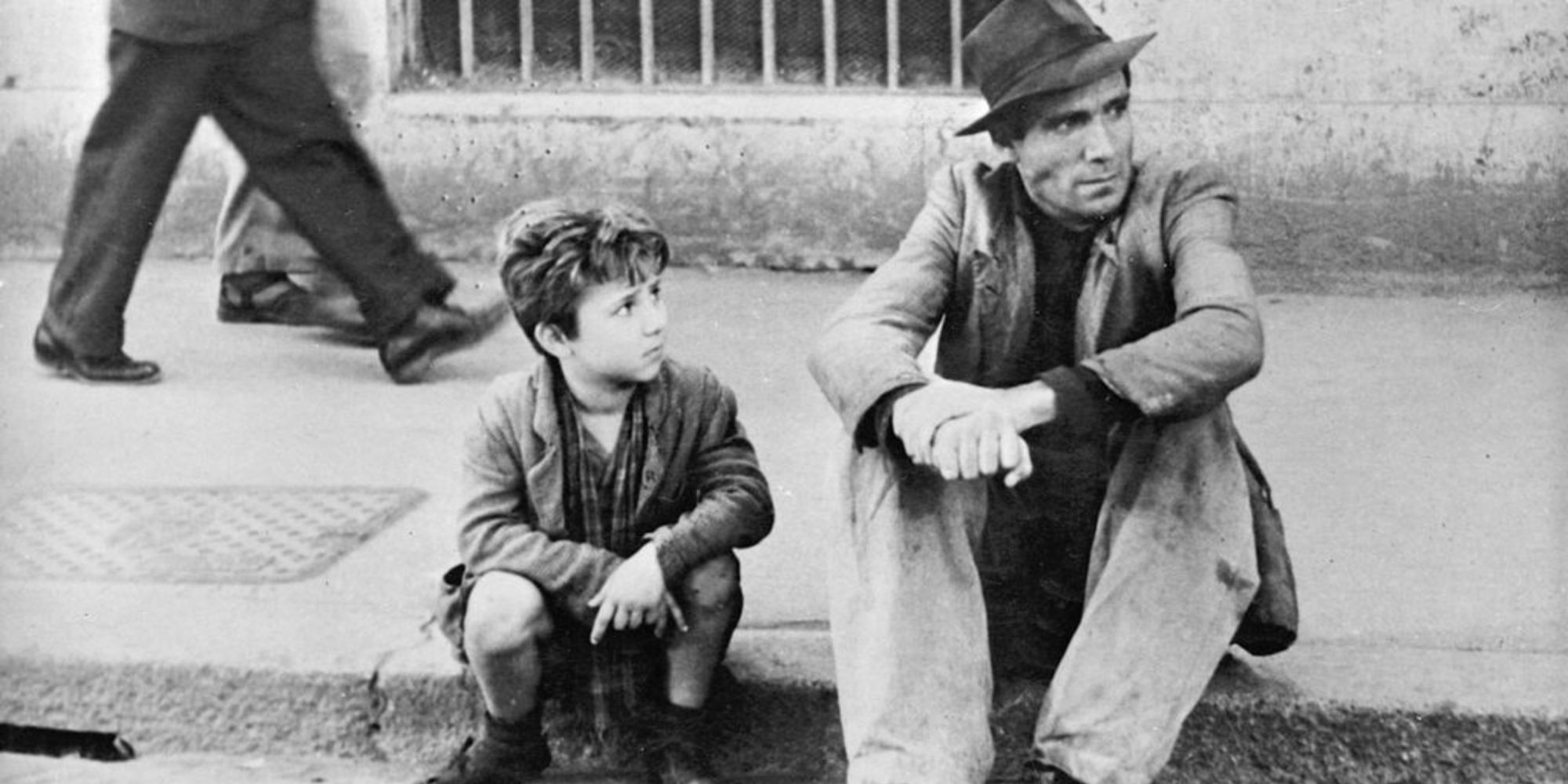 Antonio and Bruno sitting on curb in Bicycle Thieves