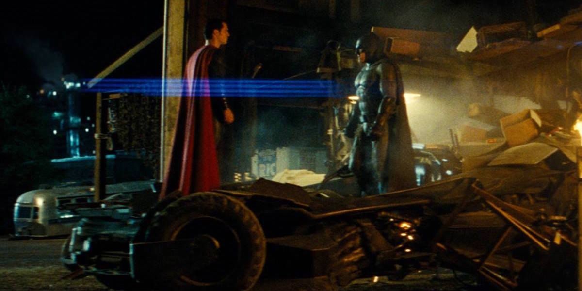 Batman and Superman face each other on top of the Batmobile in Batman v Superman