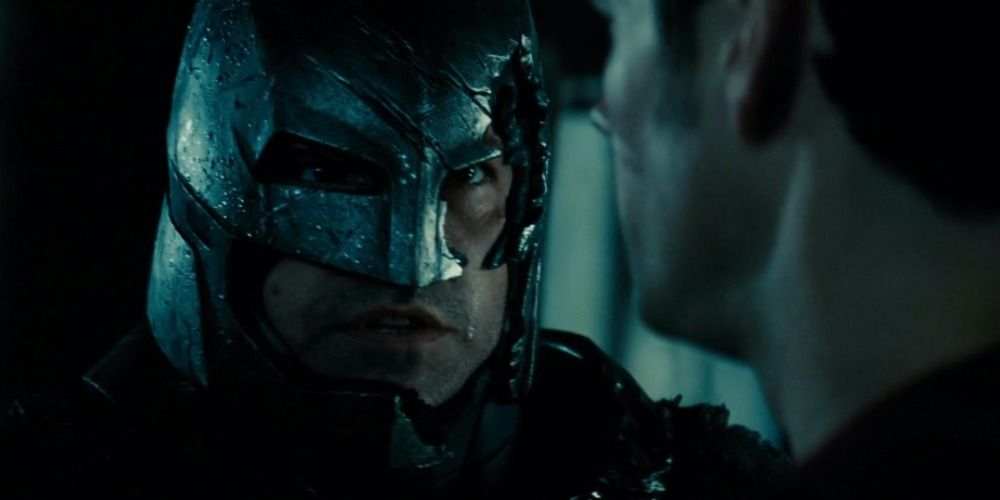 Batman in his broken armor looking at Superman in Batman v Superman
