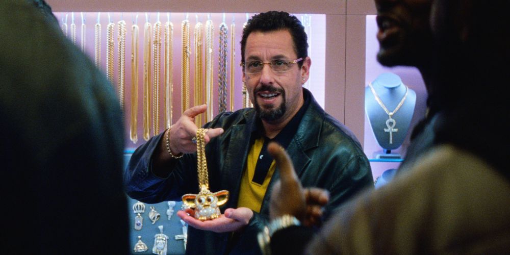 Howard showing off some jewels shows off jewelry in Uncut Gems
