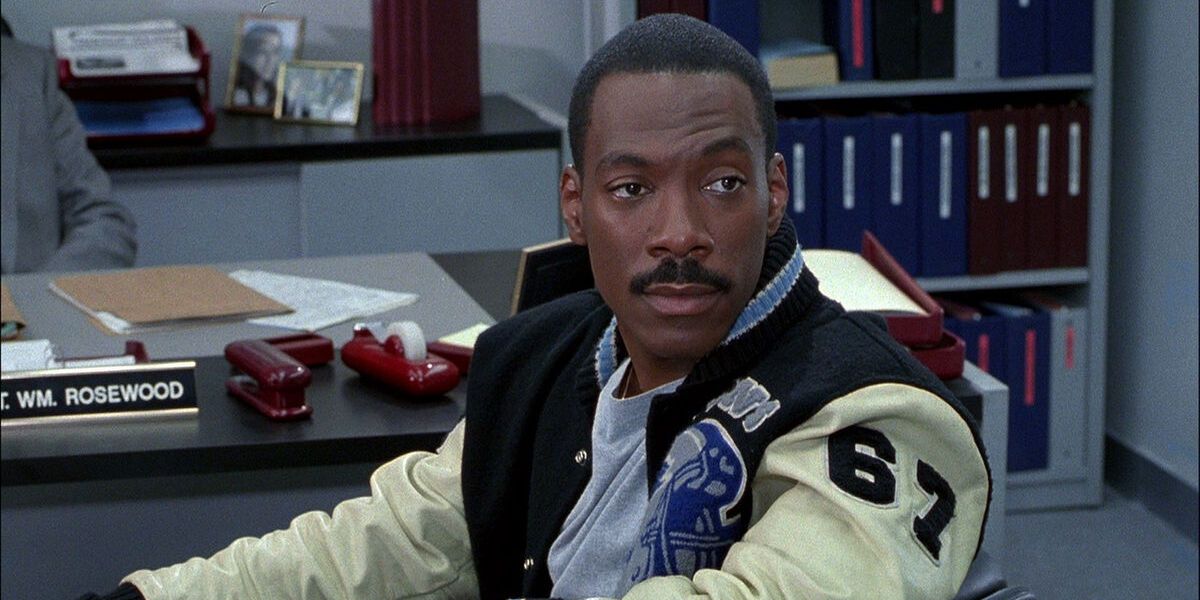 Axel Foley sitting at desk in Beverly Hills Cop 3