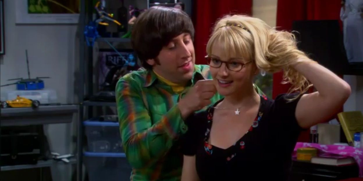 Howard puts a star pendant necklace around Bernadette's neck as she holds her hair up in The Big Bang Theory