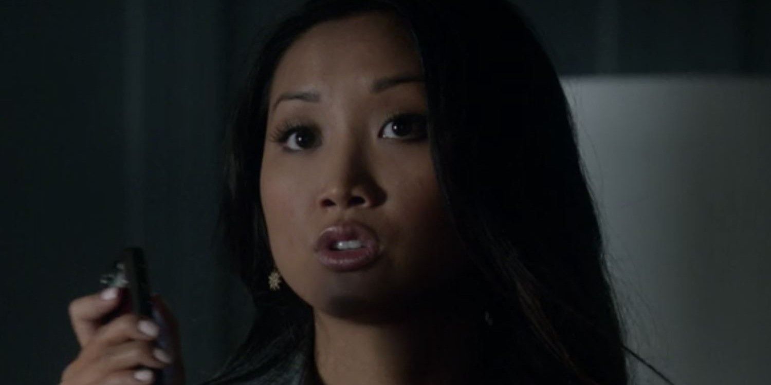 Brenda Song in Scandal close up, holding phone and talking