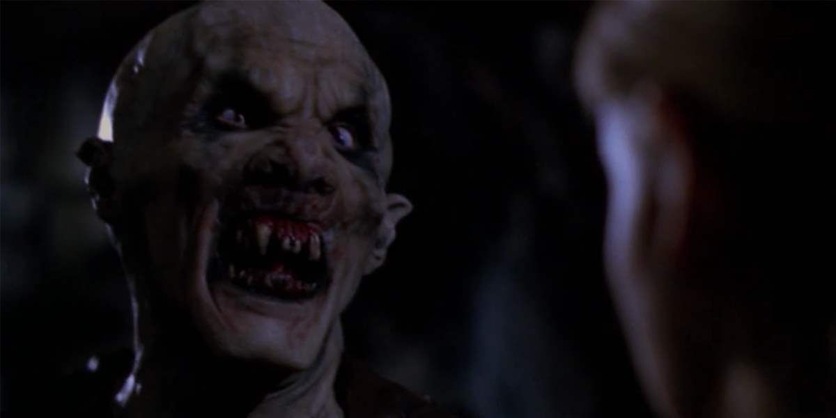 An image of an Ubervamp in Buffy The Vampire Slayer. It looks quite monstrous as it has razor sharp teeth and is trying to intimidate Buffy