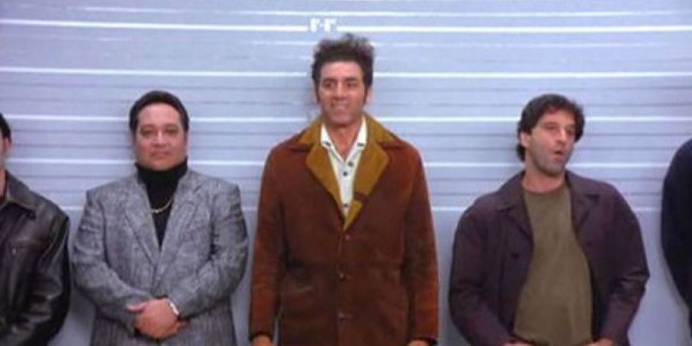 Kramer standing in the middle of five men in a police line up