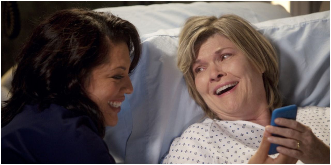 An image of Louisa and Callie laughing together. Callie is seen to be showing her pictures of Sofia on her phone