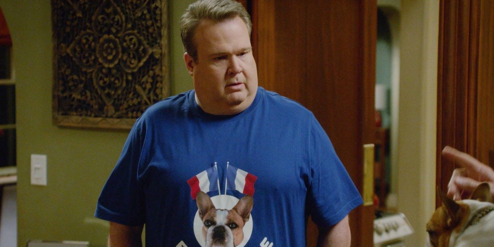Cam in blue French bulldog t-shirt, looking distressed in Modern Family