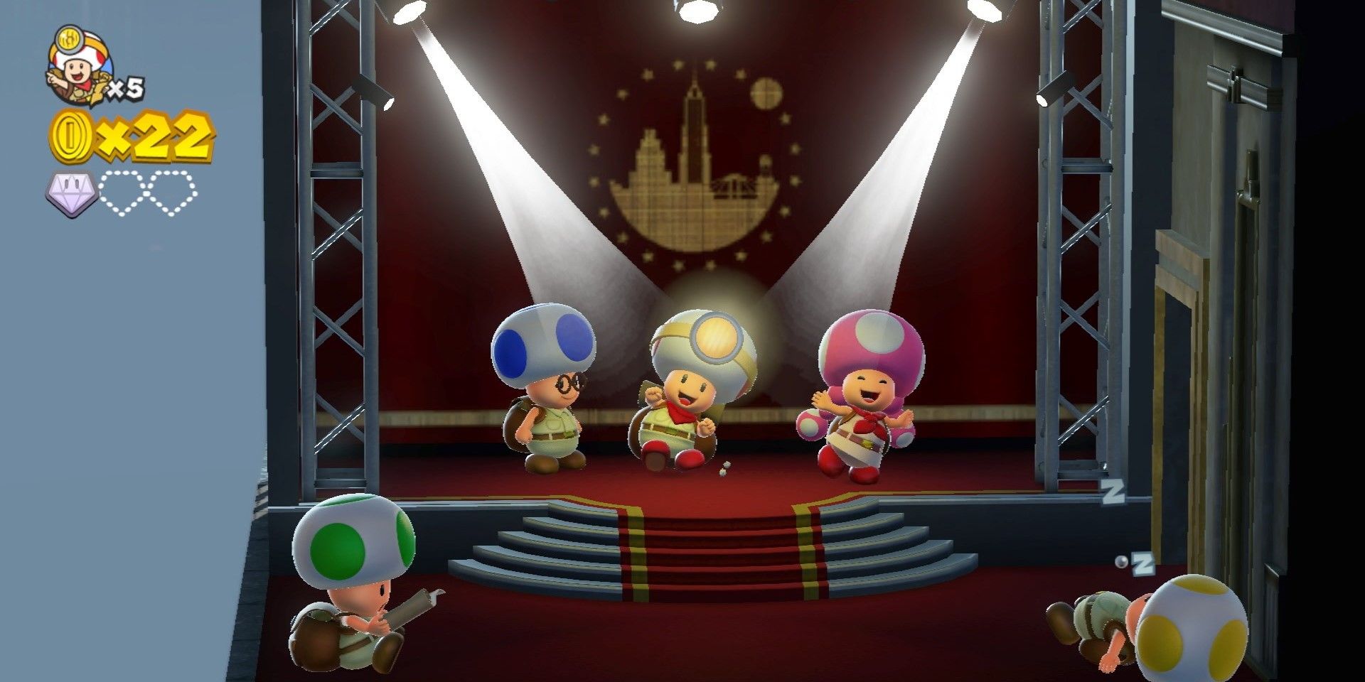 The team together in Captain Toad Treasure Tracker, on what appears to be a stage with spotlights on them