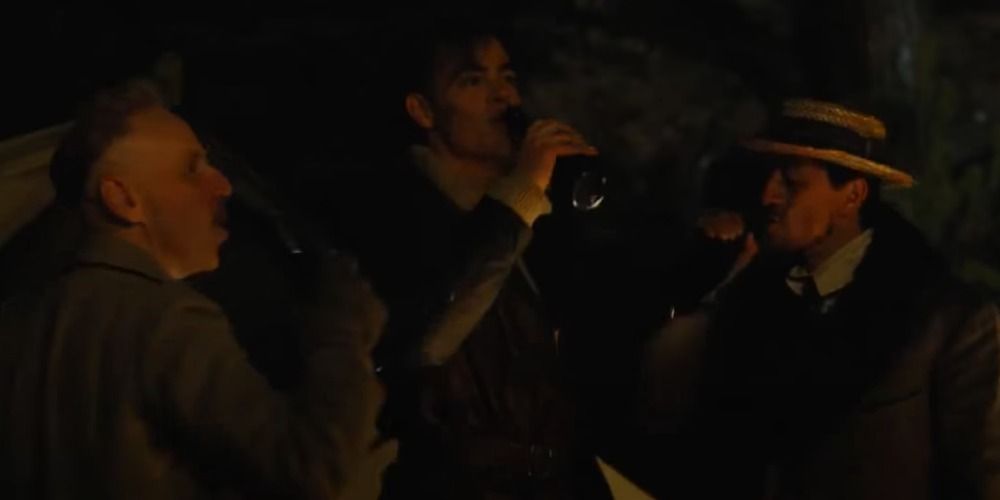 Charlie, Steve and Sameer drink together by the campfire in Wonder Woman 2017