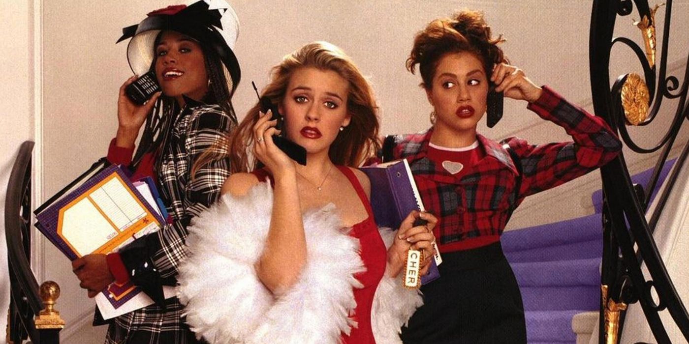 Dionne, Cher, and Tai pose on the stairs with their cell phones for the Clueless movie poster