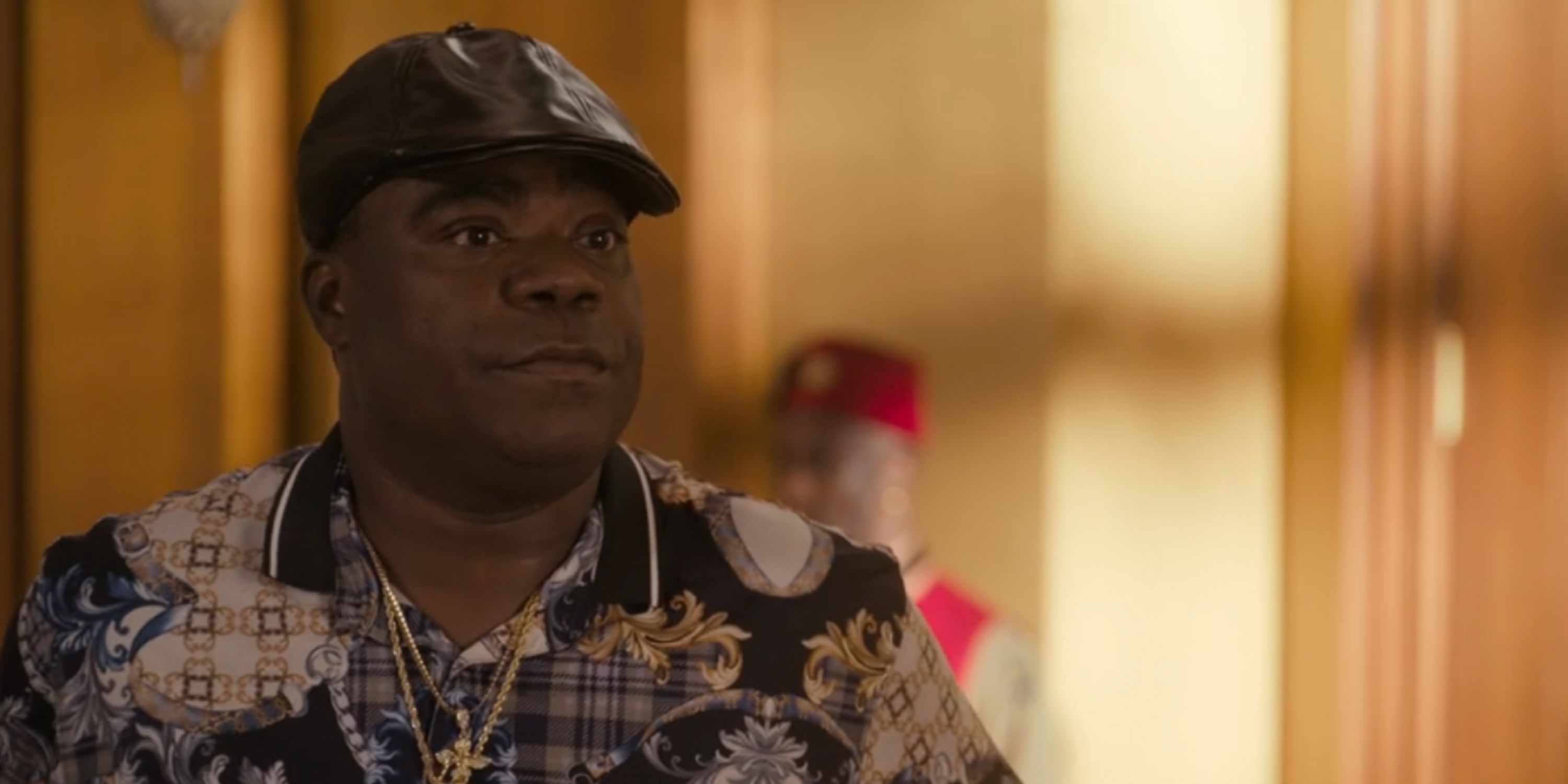 Tracy Morgan as Reem Junson in a fancy shirt and leather hat in Coming 2 America