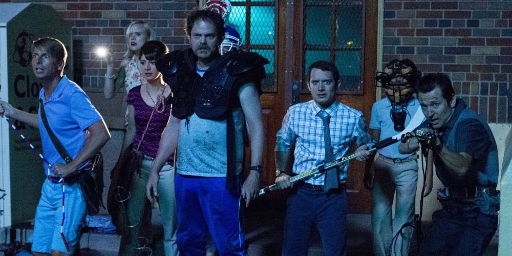 Cast of Cooties fighting off zombies with various weapons