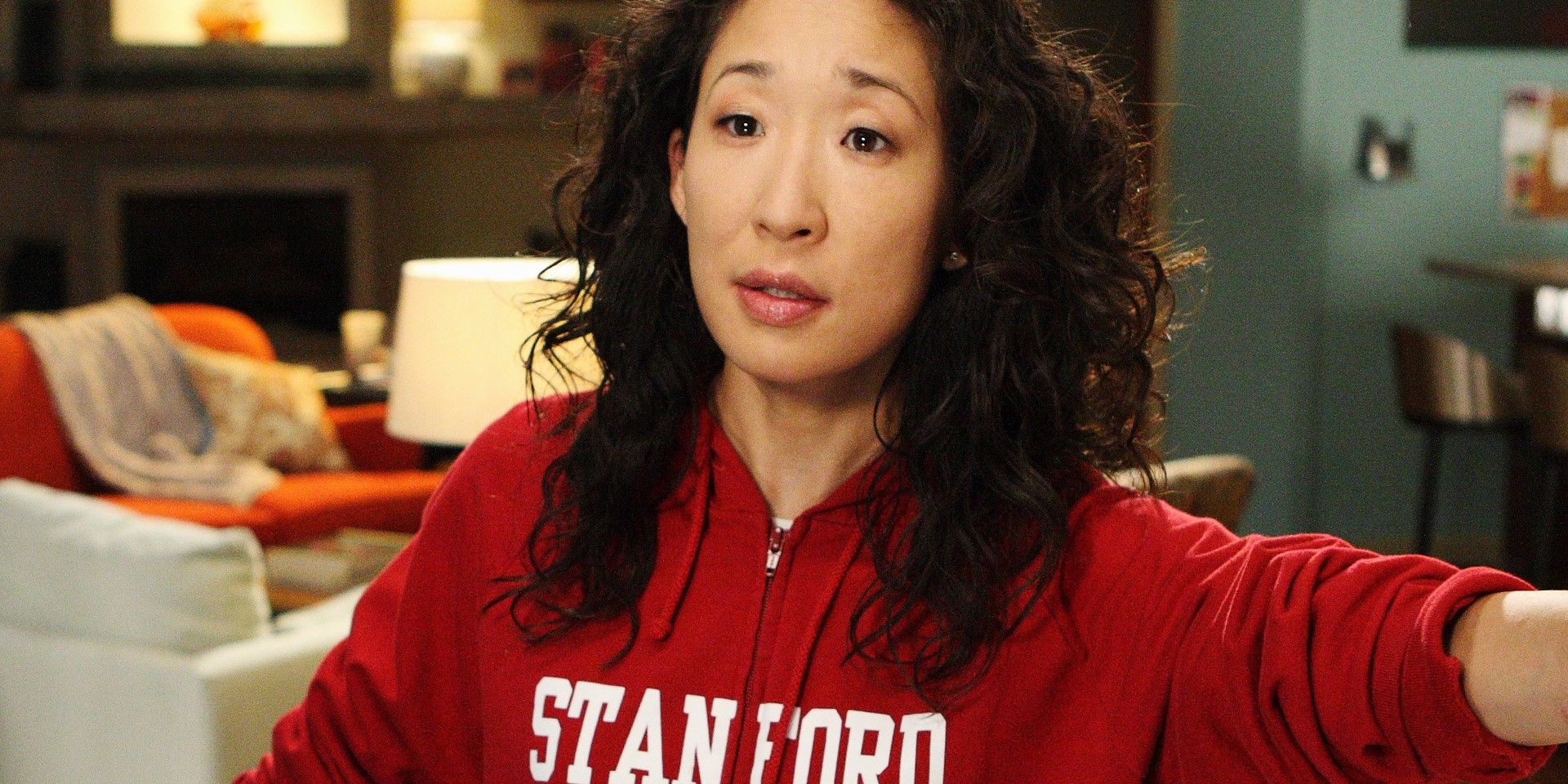 Cristina Yang in her Stanford sweatshirt with her hair down in her apartment in Grey's Anatomy