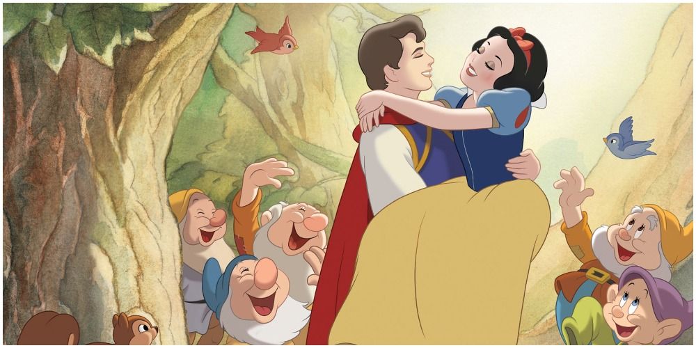 The Prince sweeps Snow White up into his arms while the dwarfs and forest animals look on in Disney's Snow White