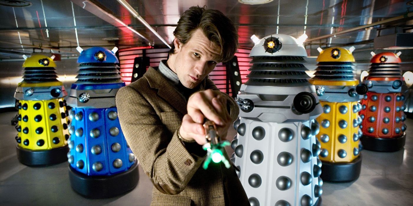 Tenth Doctor in front of the five new colorful Dalek redesigns